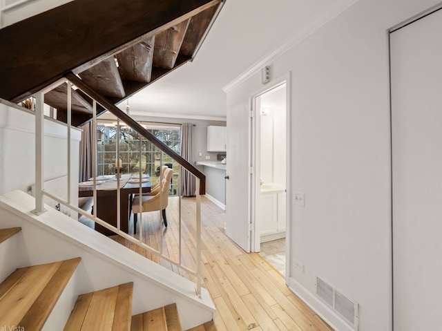 interior space featuring hardwood / wood-style flooring and ornamental molding