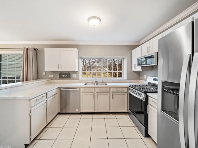 kitchen with appliances with stainless steel finishes, sink, and white cabinets