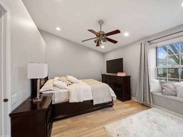 bedroom with ceiling fan and light wood-type flooring