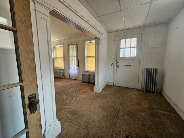 doorway to outside with radiator and dark colored carpet