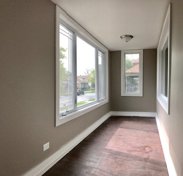 unfurnished room with dark wood-type flooring