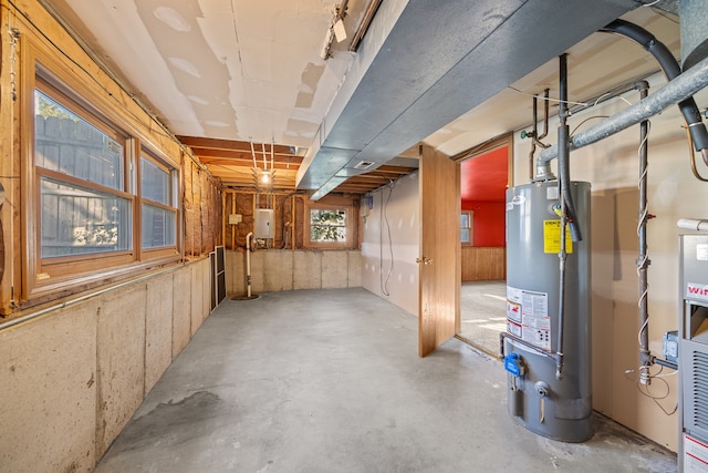 basement featuring gas water heater and electric panel