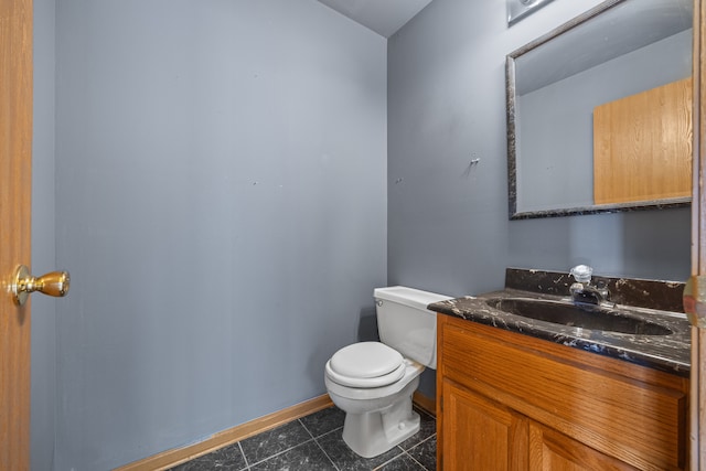 bathroom featuring tile patterned floors, vanity, and toilet