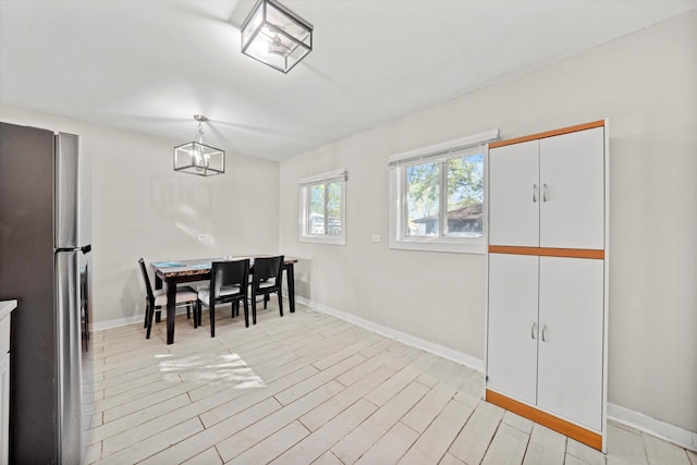 dining space with light hardwood / wood-style floors