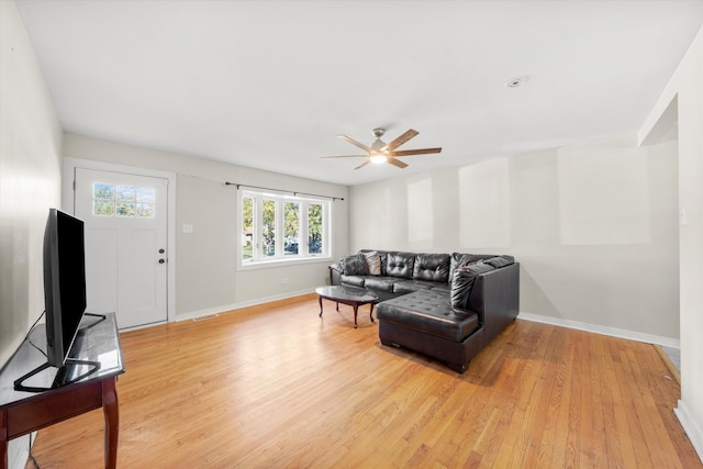 living room featuring light hardwood / wood-style floors and ceiling fan