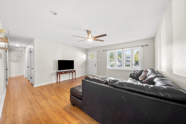 living room with light hardwood / wood-style floors and ceiling fan