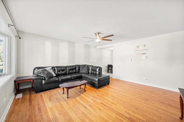 living room with light hardwood / wood-style floors and ceiling fan