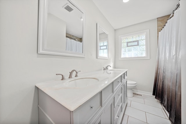 bathroom featuring vanity, toilet, and tile patterned floors