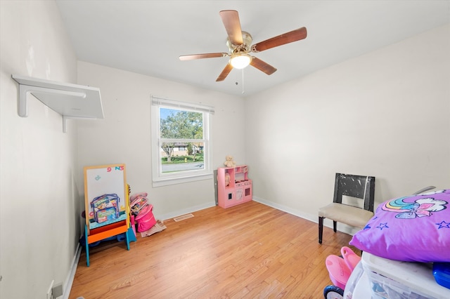 game room with light hardwood / wood-style floors and ceiling fan