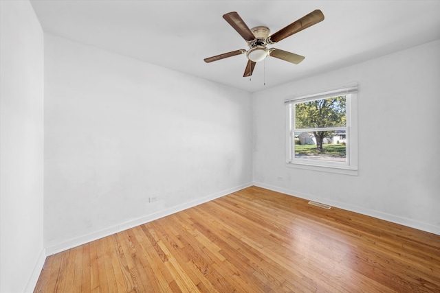 spare room with hardwood / wood-style flooring and ceiling fan