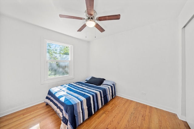 bedroom with hardwood / wood-style floors and ceiling fan