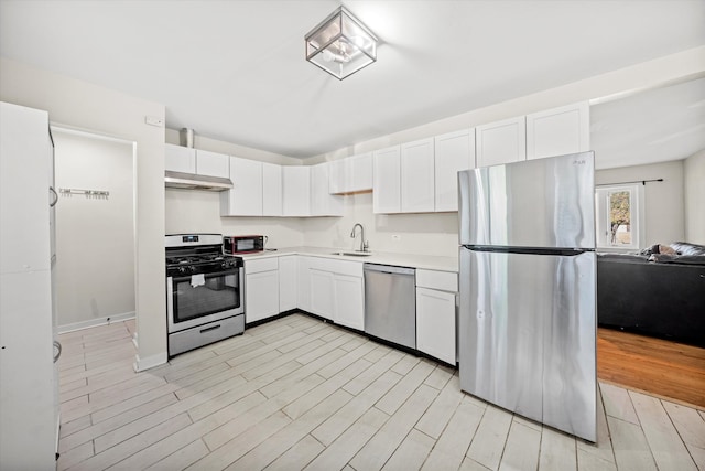 kitchen with sink, stainless steel appliances, light hardwood / wood-style flooring, and white cabinets