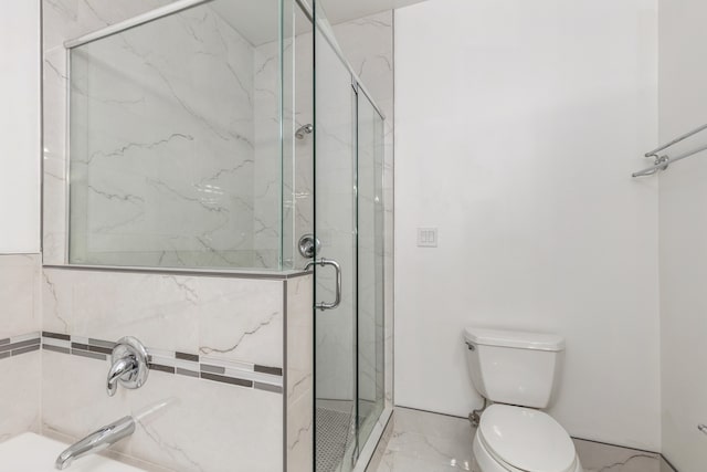 bathroom with a shower with door and toilet