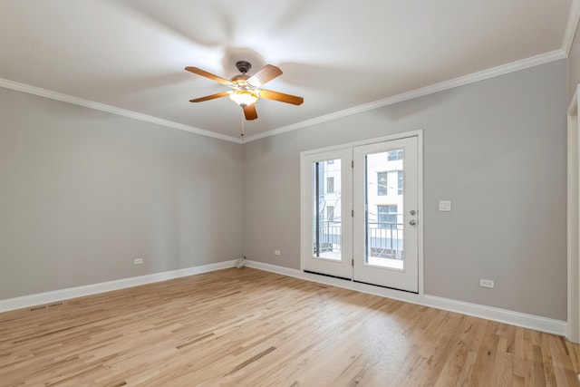 spare room featuring ceiling fan, light wood-type flooring, and crown molding