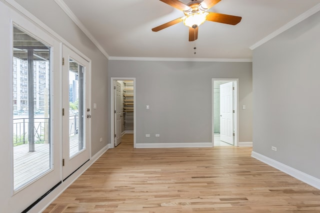 unfurnished room with ceiling fan, crown molding, and light hardwood / wood-style floors