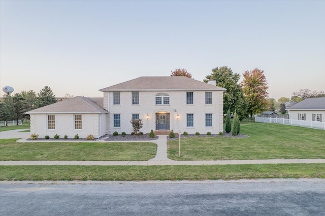 colonial inspired home featuring a lawn