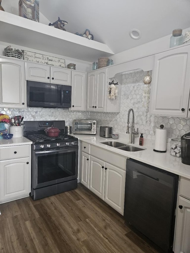 kitchen featuring black appliances, white cabinetry, tasteful backsplash, and sink