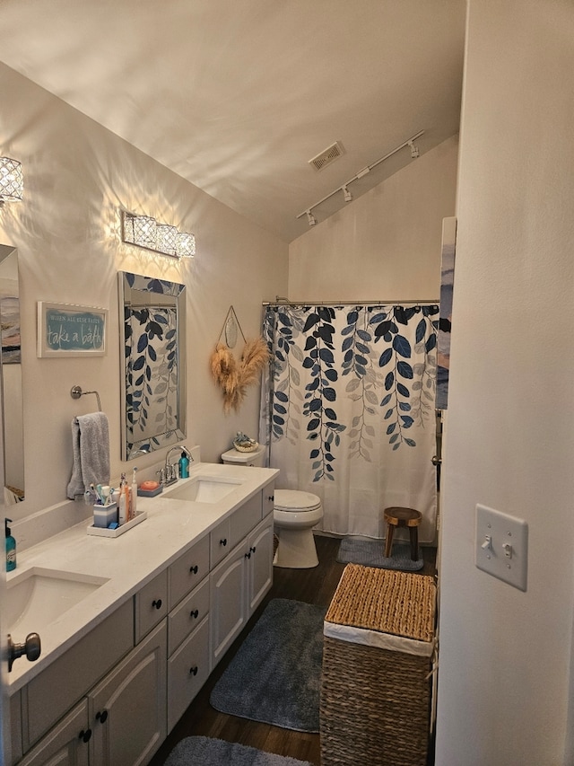 17437 Yakima Dr, Lockport, IL 60441 - bathroom featuring visible vents, a sink, toilet, wood finished floors, and lofted ceiling