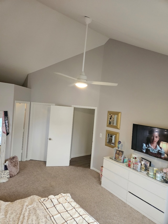 carpeted bedroom featuring high vaulted ceiling, a closet, and ceiling fan