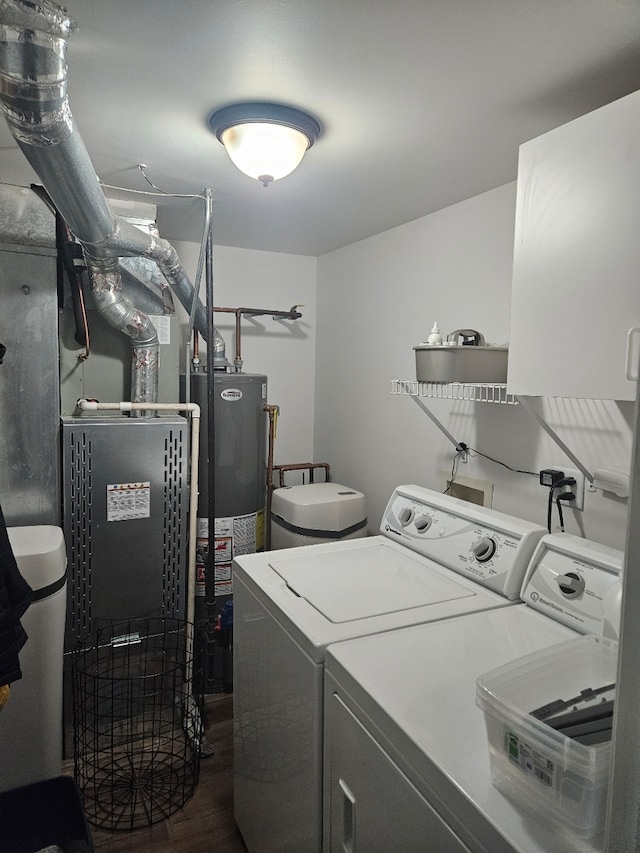 laundry room featuring separate washer and dryer, gas water heater, and dark hardwood / wood-style flooring