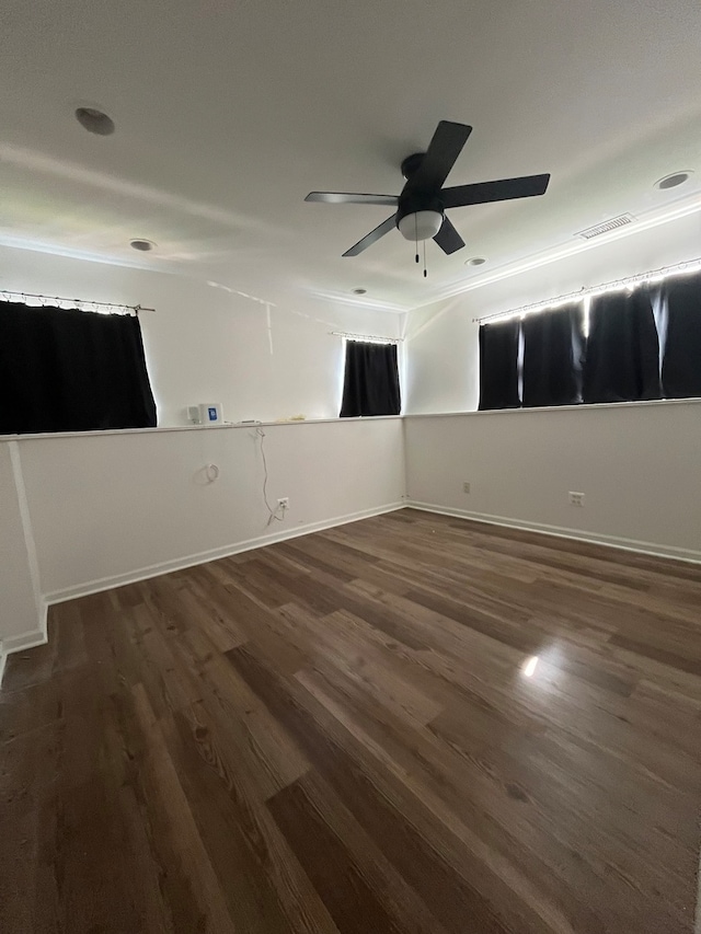 empty room featuring ceiling fan and dark wood-type flooring