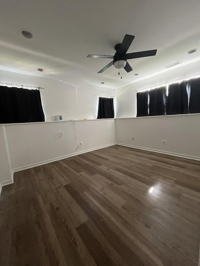 17437 Yakima Dr, Lockport, IL 60441 - unfurnished room with baseboards, dark wood-style flooring, ceiling fan, and visible vents
