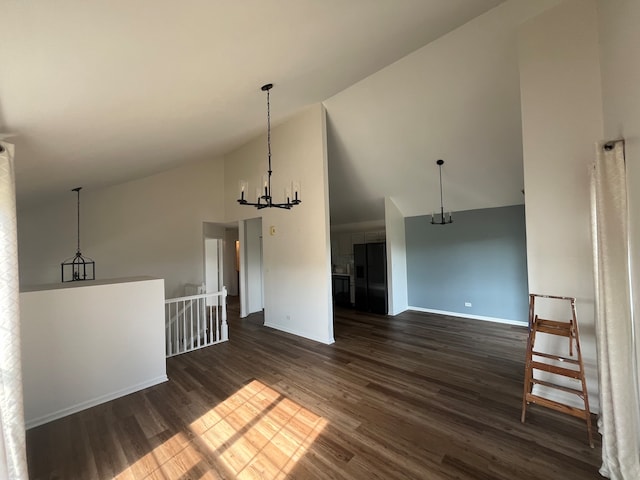 unfurnished dining area featuring a notable chandelier, dark hardwood / wood-style flooring, and high vaulted ceiling