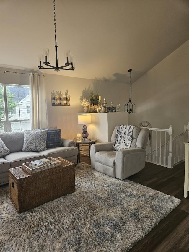 living room with dark hardwood / wood-style floors and a chandelier