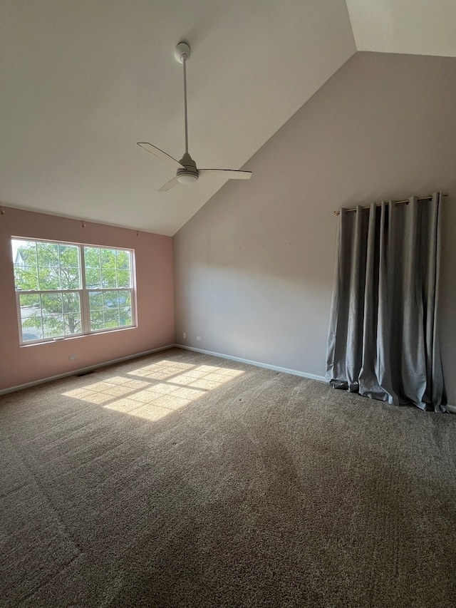 carpeted empty room featuring ceiling fan and vaulted ceiling