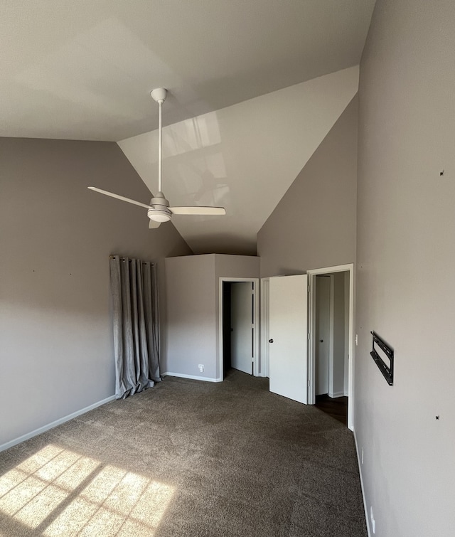 unfurnished bedroom with lofted ceiling, dark colored carpet, and ceiling fan