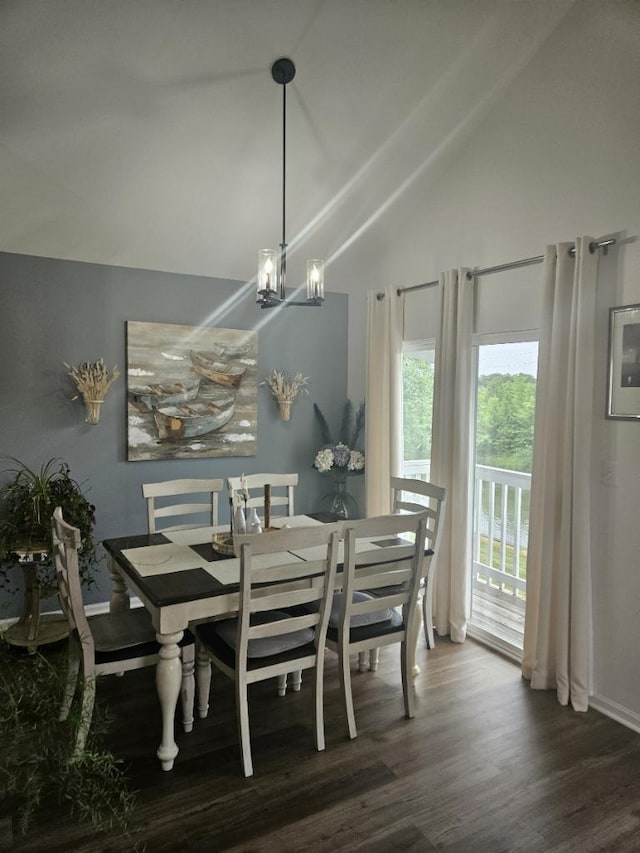 dining room featuring an inviting chandelier, lofted ceiling, and dark hardwood / wood-style floors