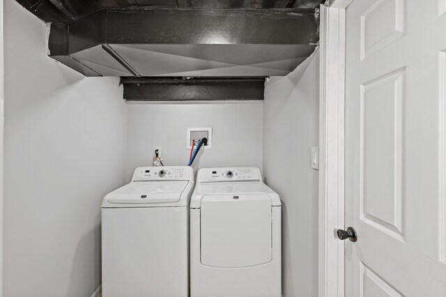 clothes washing area featuring separate washer and dryer