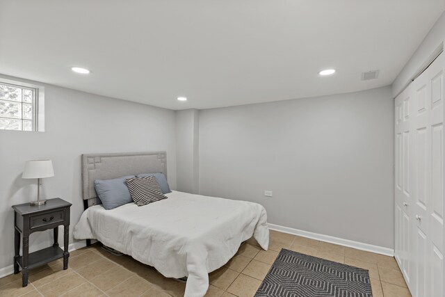 tiled bedroom with a closet