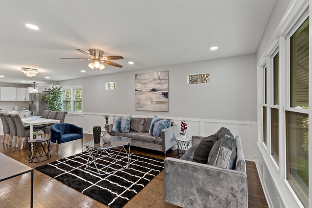 living room featuring dark hardwood / wood-style floors and ceiling fan