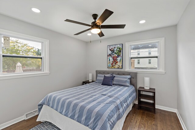 bedroom with ceiling fan and dark hardwood / wood-style flooring