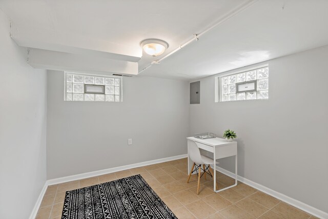 basement with light tile patterned floors and electric panel