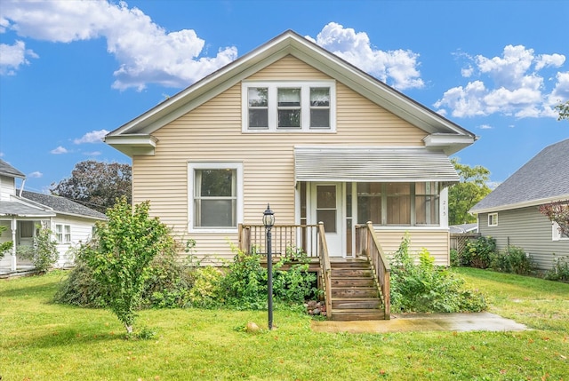 view of front facade with a front lawn and a sunroom