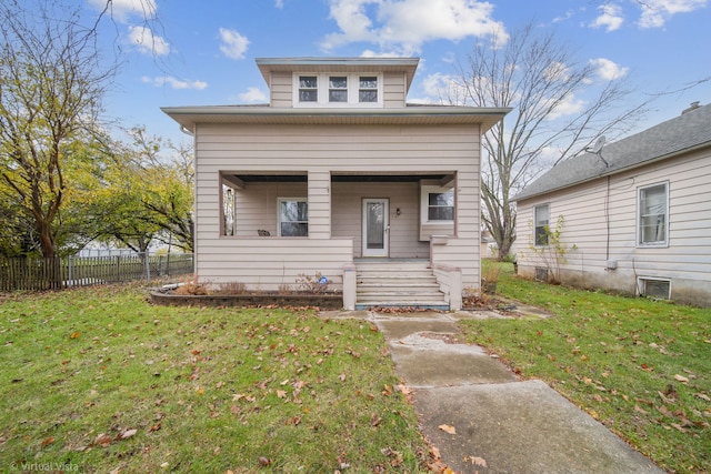 bungalow-style home with a front yard