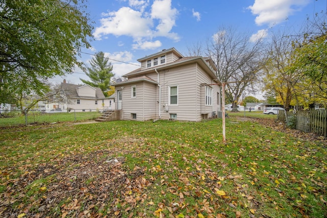 back of property with a lawn