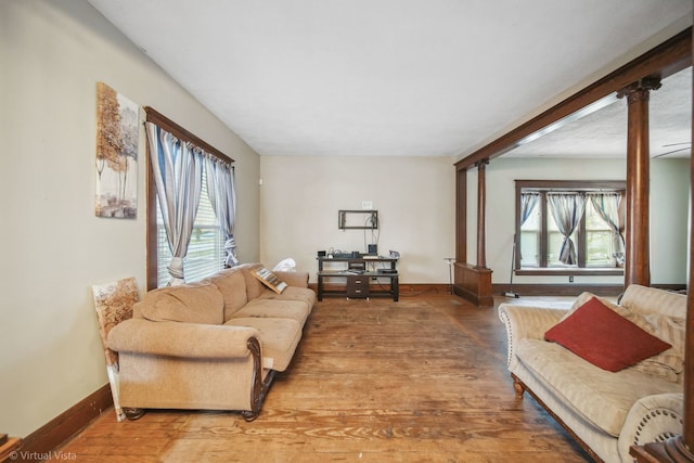 living room featuring hardwood / wood-style flooring and ornate columns