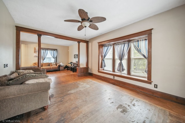 living room with ceiling fan and hardwood / wood-style flooring