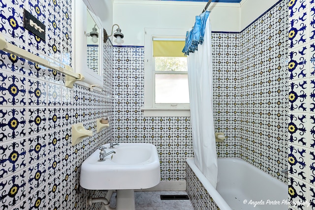 bathroom featuring tile patterned floors, tile walls, and shower / bath combination with curtain