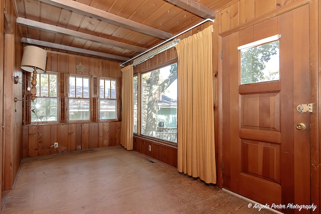 unfurnished sunroom featuring a wealth of natural light and wooden ceiling