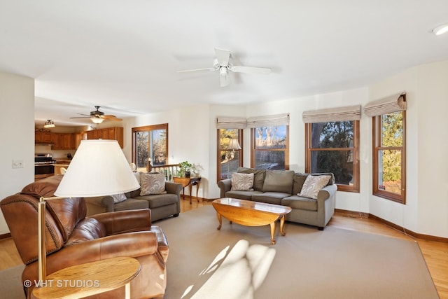 living room featuring light hardwood / wood-style floors and ceiling fan