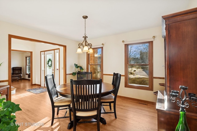 dining area featuring light wood-type flooring