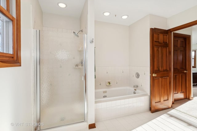 bathroom featuring tile patterned floors and shower with separate bathtub