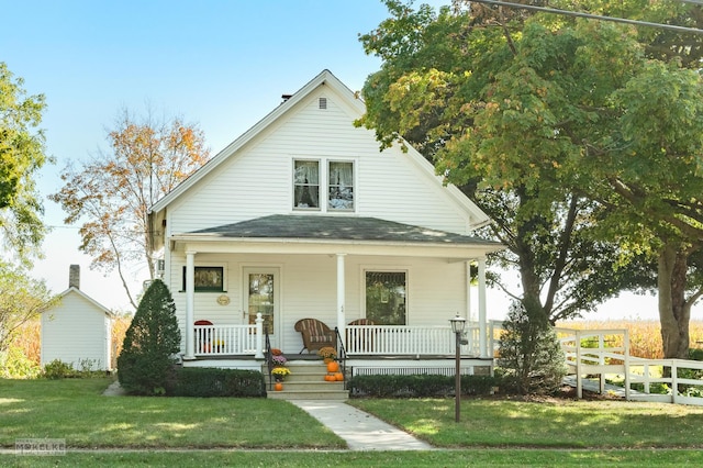 bungalow-style house with roof with shingles, a porch, fence, and a front lawn