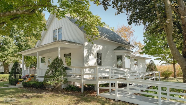 rear view of property with covered porch