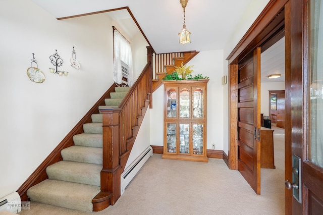 stairs featuring baseboards, carpet flooring, and a baseboard heating unit