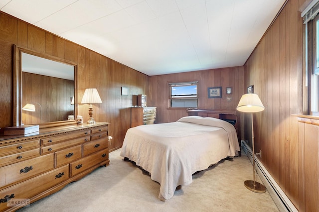 bedroom featuring light carpet, wooden walls, and a baseboard radiator